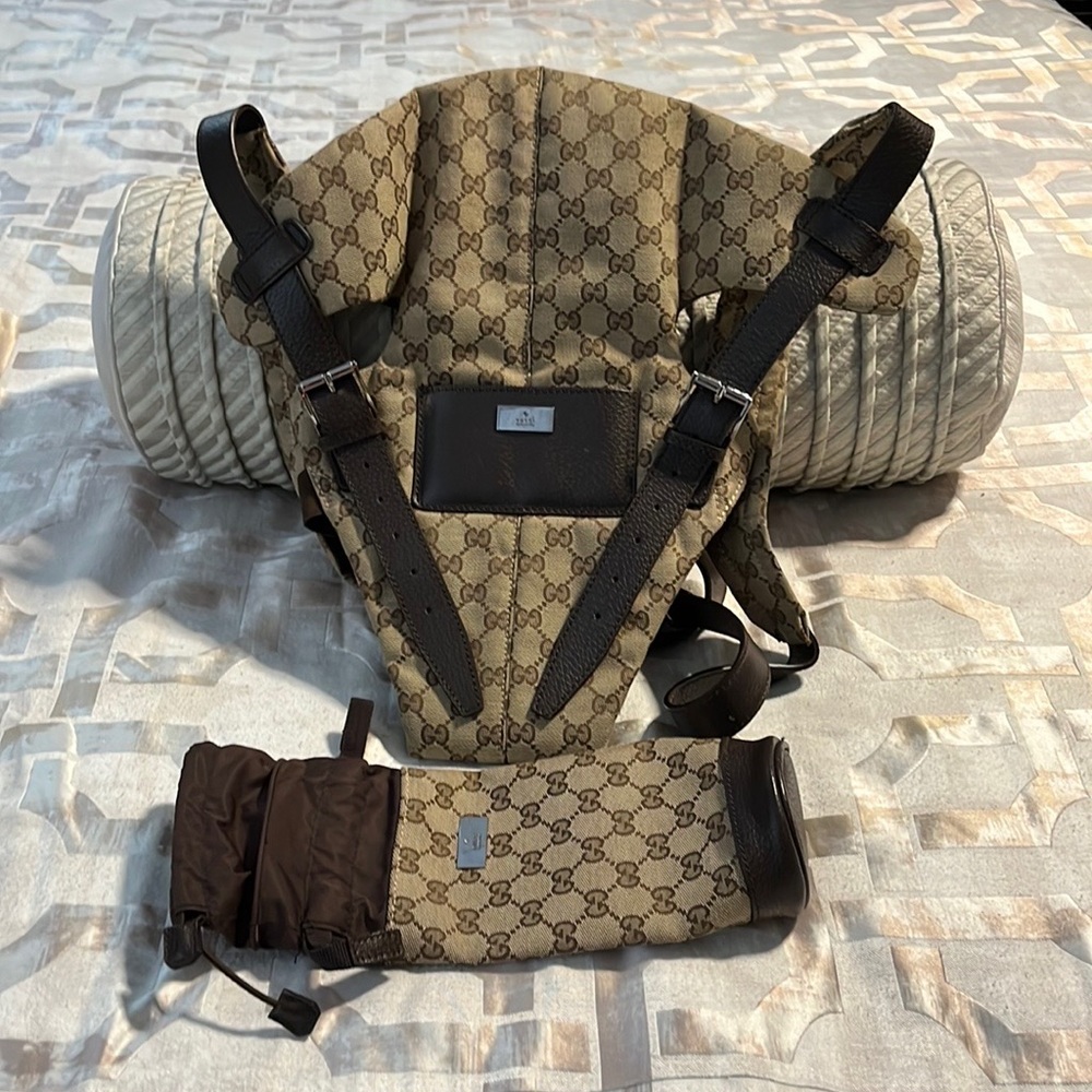 Designer GG baby carrier and bottle holder.